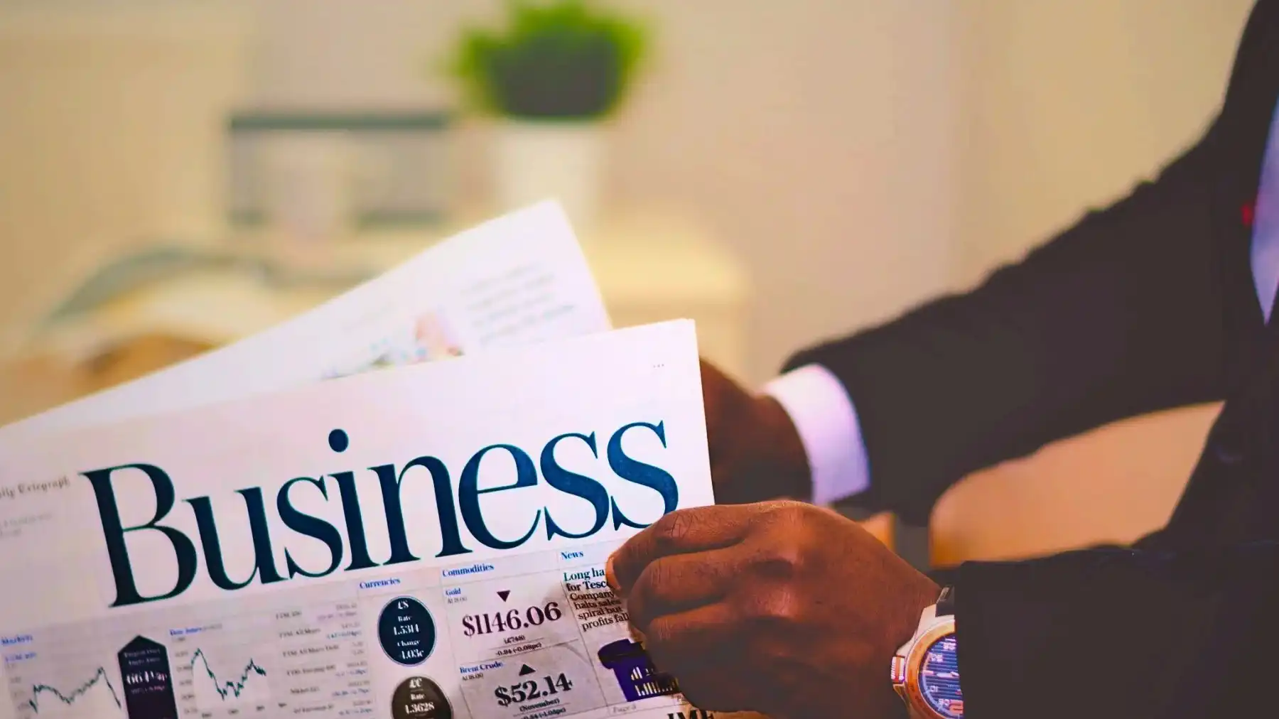 image of a black guy holding a newspaper.